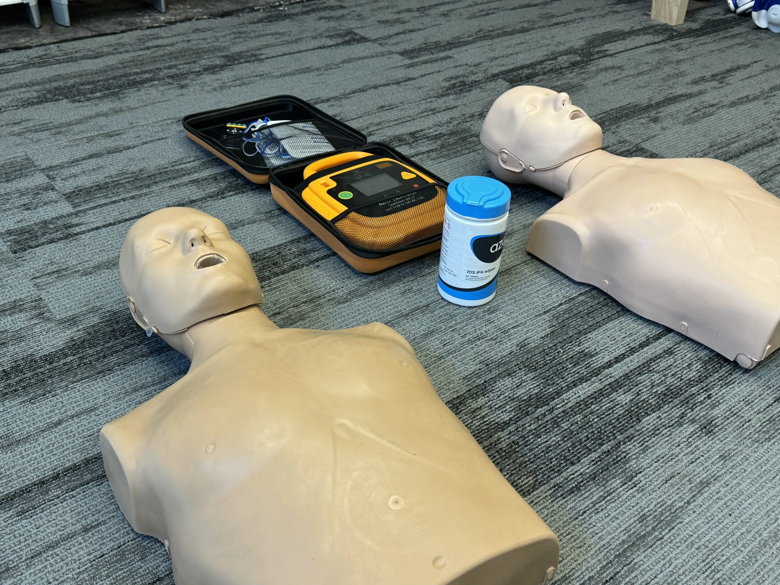 CPR and AED training equipment laid out for emergency readiness.